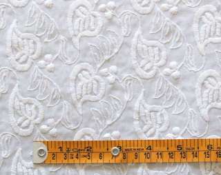 This is a machine embroidered fabric with a dense pattern of flowers 