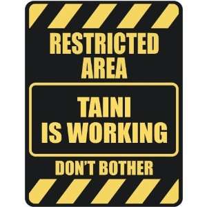   RESTRICTED AREA TAINI IS WORKING  PARKING SIGN