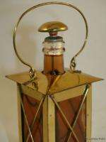   Lantern shaped brass and glass bottle decanter with Swiss music box
