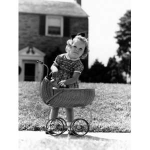  on Sidewalk in Front of House Reaching Into Baby Carriage For Doll 